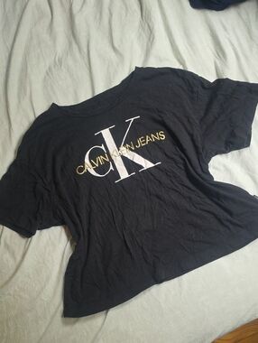 Calvin Klein Jeans Black Tee with White CK and Gold Lettering